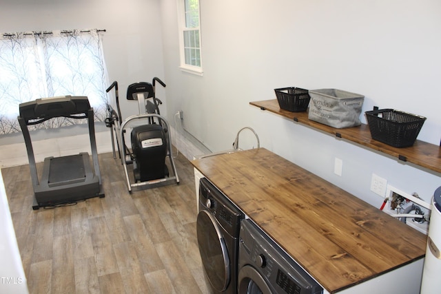 5920 Whittier Dr, Raleigh, NC 27609 - workout area with a wealth of natural light, light wood-style floors, and washer and clothes dryer