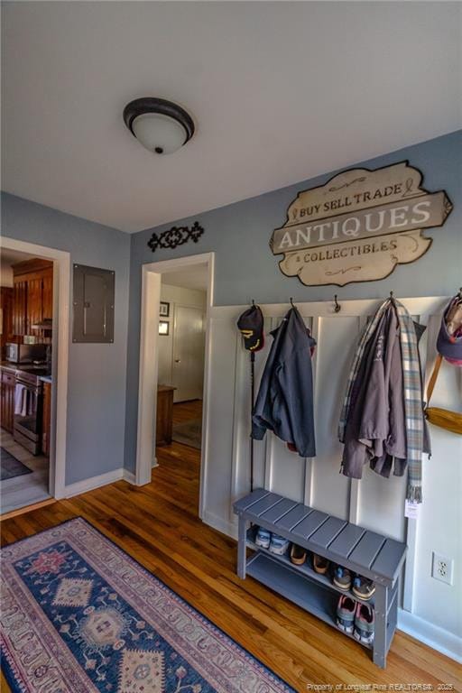 mudroom with hardwood / wood-style floors and electric panel