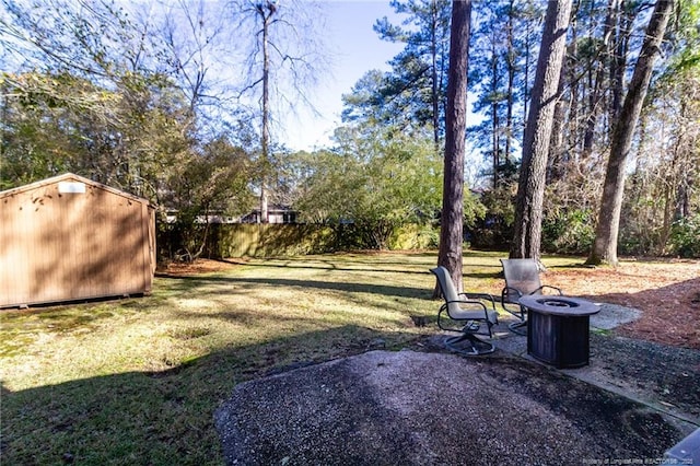 view of yard featuring a storage unit and a fire pit