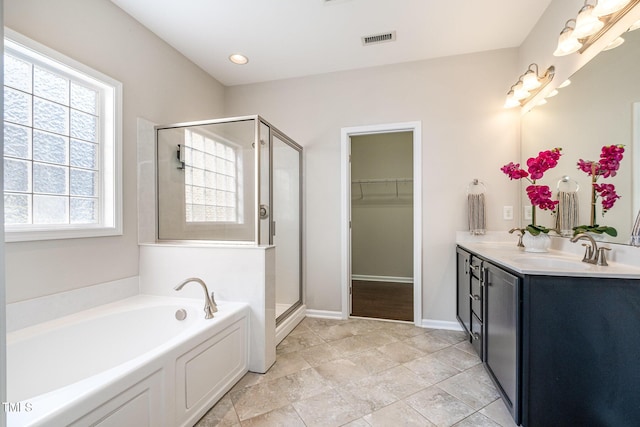 bathroom with vanity and separate shower and tub