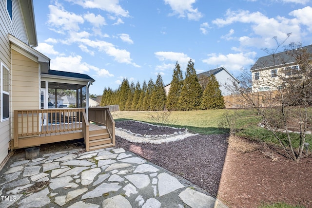 view of yard featuring a wooden deck, a patio, and a sunroom