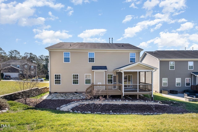 back of house with a deck and a lawn