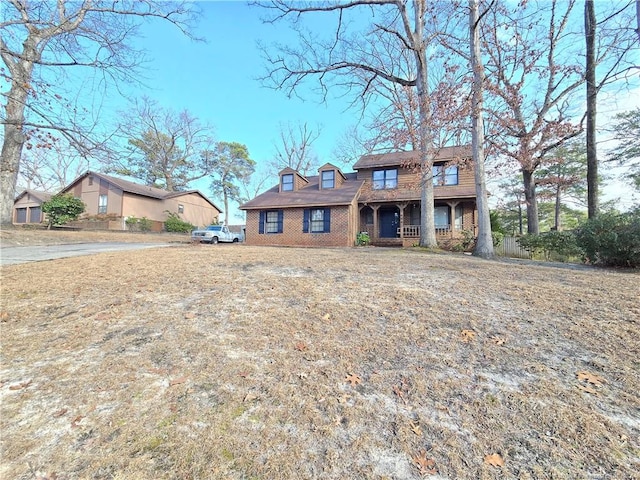 view of front of house with a porch and a front yard