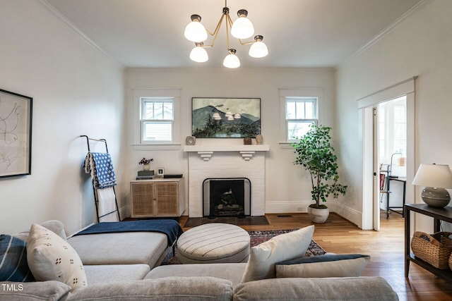 living room featuring a fireplace, ornamental molding, and a healthy amount of sunlight