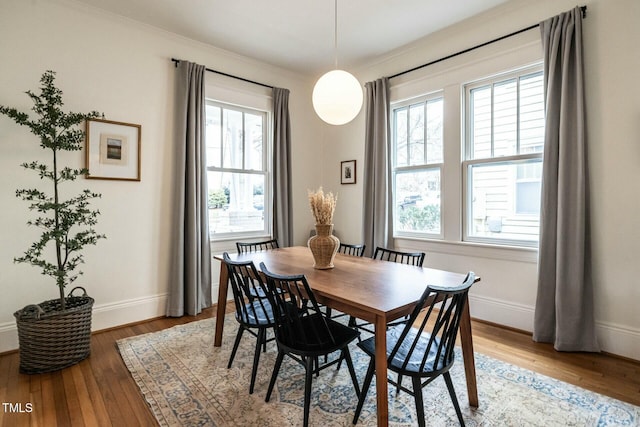 dining room featuring wood-type flooring and crown molding