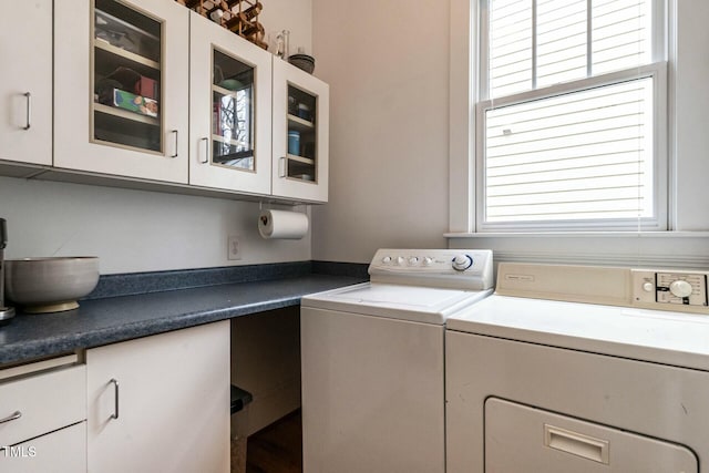 washroom featuring cabinets and washer and dryer