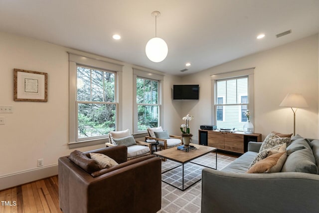 living room featuring vaulted ceiling and light hardwood / wood-style floors