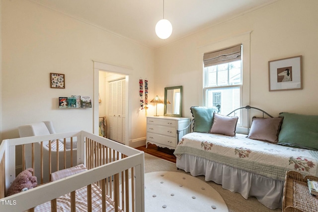 bedroom with ornamental molding and carpet floors