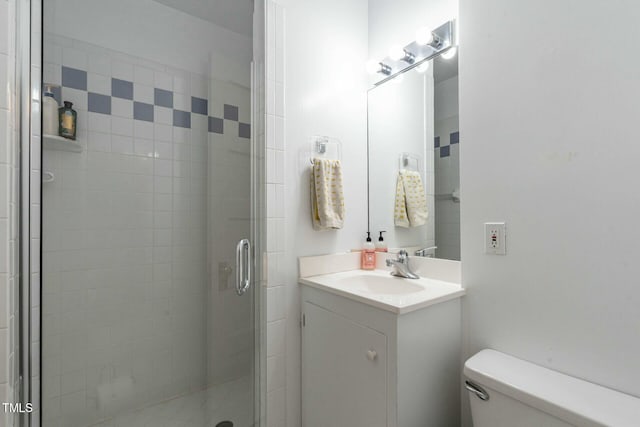 bathroom with vanity, toilet, and walk in shower