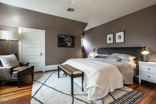 bedroom with dark hardwood / wood-style flooring