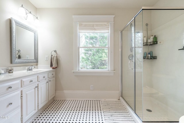 bathroom with vanity and a shower with shower door