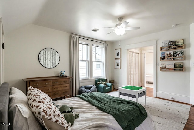 bedroom featuring hardwood / wood-style flooring, lofted ceiling, and ceiling fan