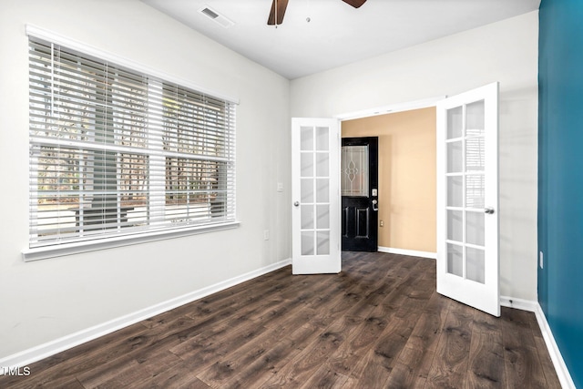 spare room featuring dark hardwood / wood-style floors, ceiling fan, and french doors