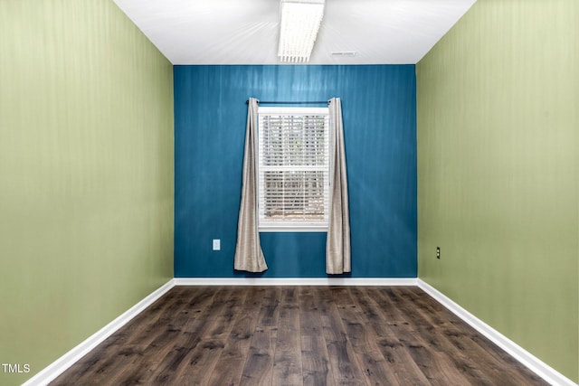 empty room featuring dark hardwood / wood-style flooring