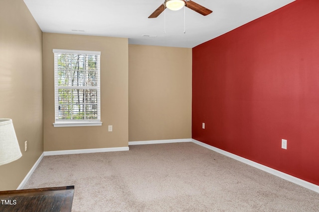 spare room featuring ceiling fan and carpet flooring