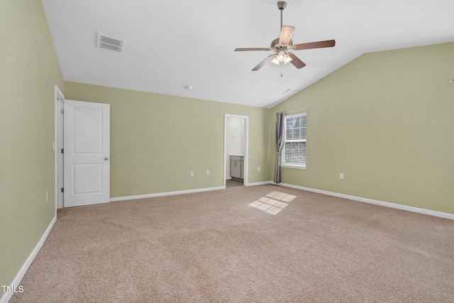 spare room featuring lofted ceiling, light colored carpet, and ceiling fan