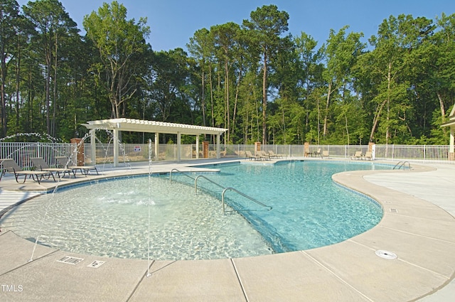 view of pool with a pergola and a patio area