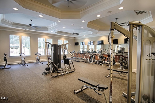 workout area with a raised ceiling and ceiling fan