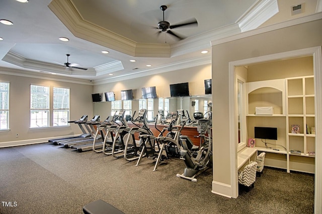 workout area with crown molding, a tray ceiling, and ceiling fan