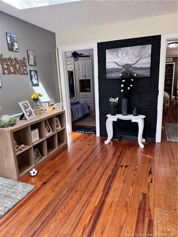 interior space with wood-type flooring and a textured ceiling