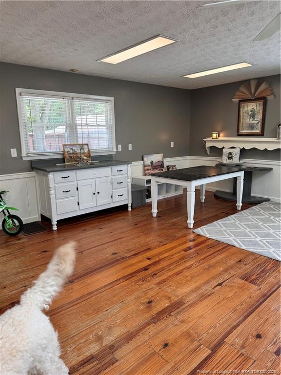 game room with dark hardwood / wood-style floors and a textured ceiling