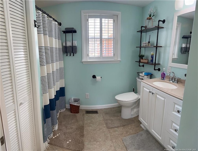 bathroom with tile patterned floors, vanity, and toilet