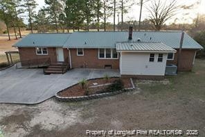 back of property with a patio and central air condition unit