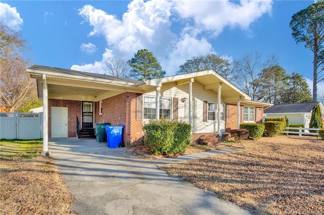 ranch-style home with a garage and a carport