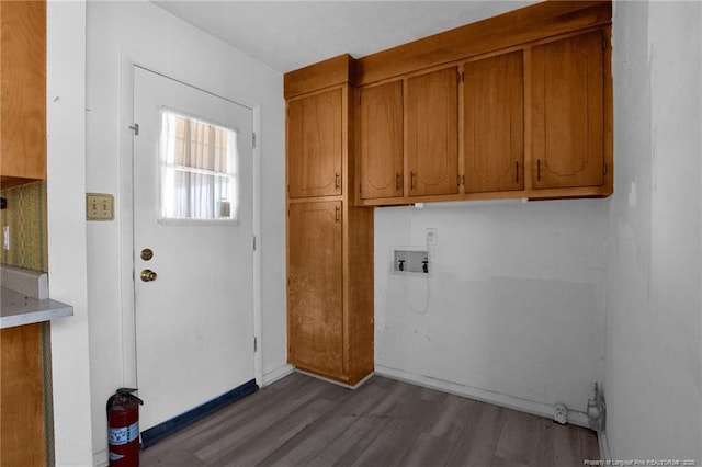 clothes washing area featuring washer hookup, hardwood / wood-style flooring, and cabinets