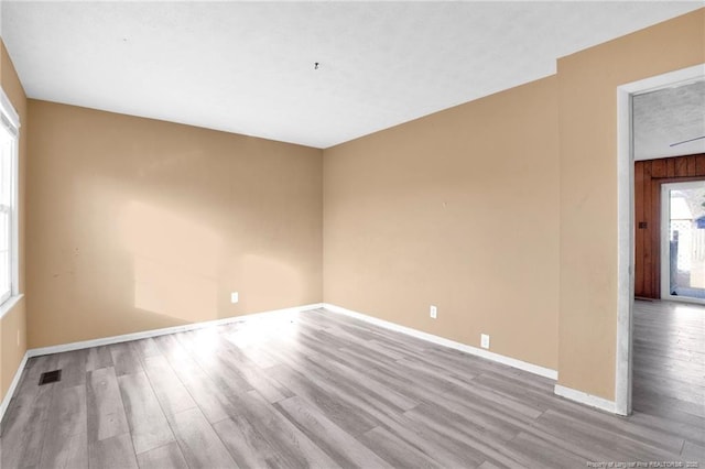 spare room featuring light hardwood / wood-style flooring