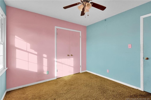 interior space with ceiling fan, carpet floors, and a closet