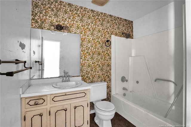 full bathroom with vanity, toilet, and  shower combination