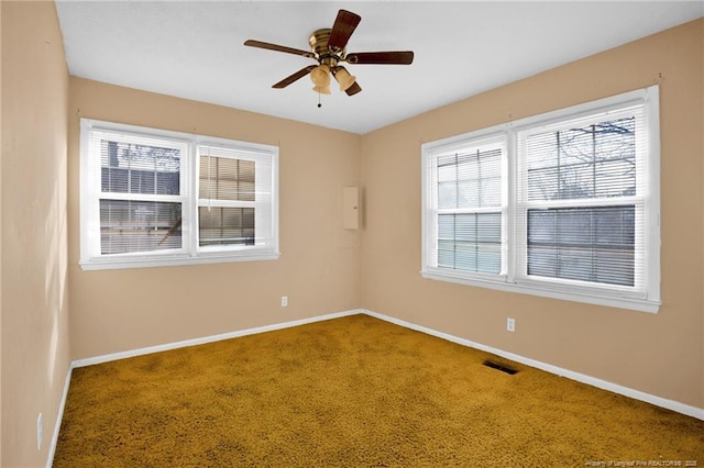 unfurnished room with ceiling fan and carpet flooring