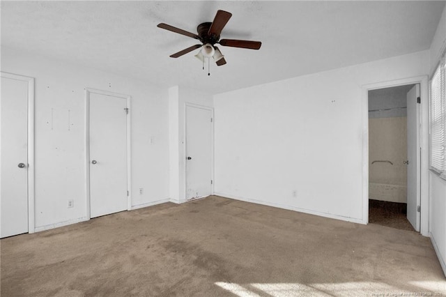 unfurnished bedroom with ceiling fan and light colored carpet