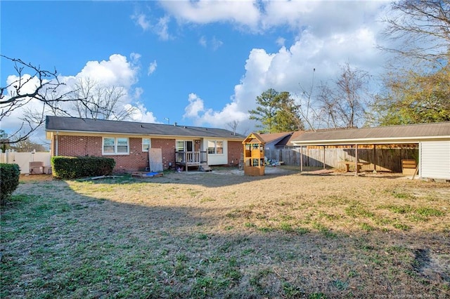 rear view of property featuring a lawn