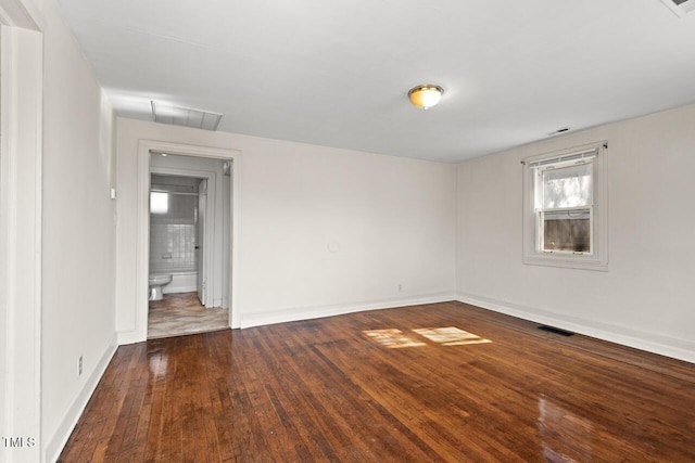 unfurnished room featuring dark wood-type flooring