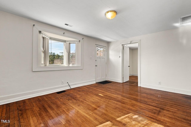 spare room with dark wood-type flooring