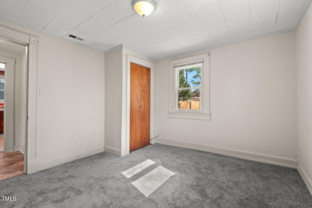 unfurnished bedroom with a closet and carpet flooring