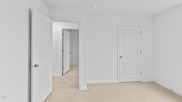 spare room featuring light colored carpet