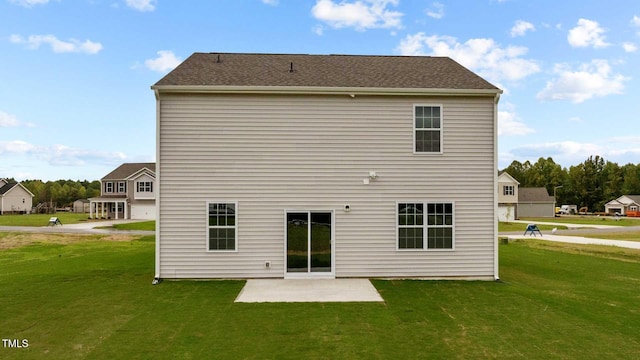 back of property featuring a yard and a patio