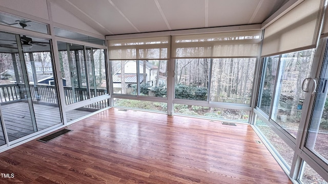 unfurnished sunroom with vaulted ceiling and ceiling fan