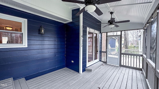 unfurnished sunroom with ceiling fan