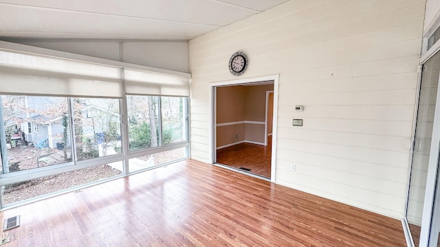 unfurnished sunroom with vaulted ceiling