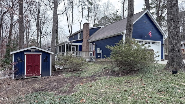 view of property exterior with a storage shed and a garage