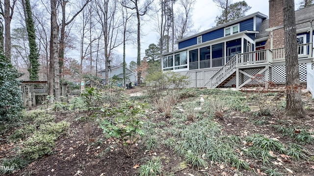 view of yard with a wooden deck and a sunroom