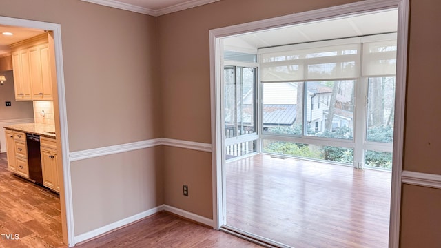 doorway to outside featuring crown molding and light hardwood / wood-style flooring