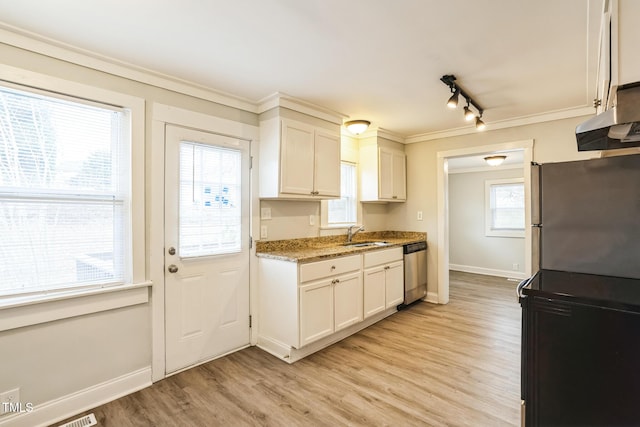 kitchen featuring appliances with stainless steel finishes, sink, white cabinets, and light wood-type flooring