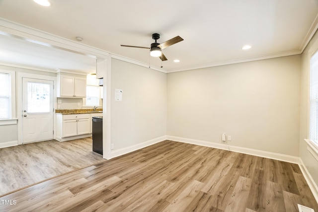 interior space featuring white cabinetry, dishwasher, crown molding, and light hardwood / wood-style floors