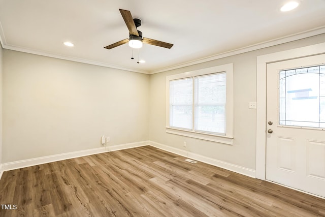 entryway featuring ornamental molding, wood-type flooring, and ceiling fan