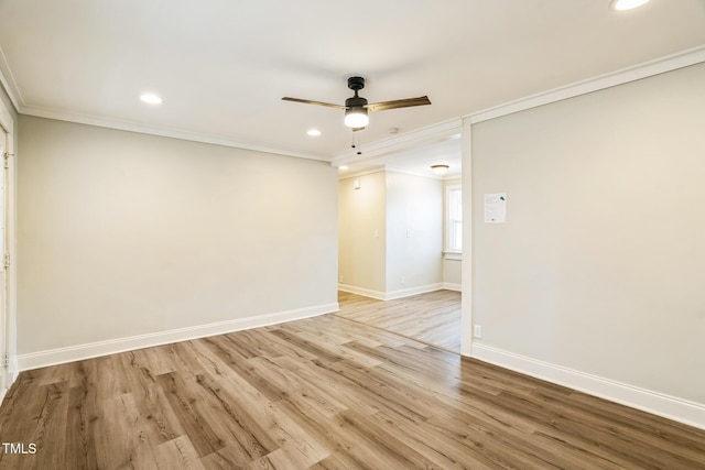 empty room featuring ornamental molding, light hardwood / wood-style floors, and ceiling fan